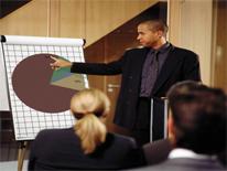 Man pointing to pie chart during presentation