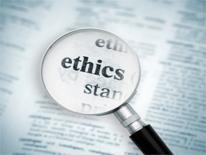 Magnifying glass with a display of the word ethics